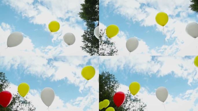 夏天天空背景下美丽的彩色气球。媒体。空气中的爱情夏天，婚礼，生日，假期。