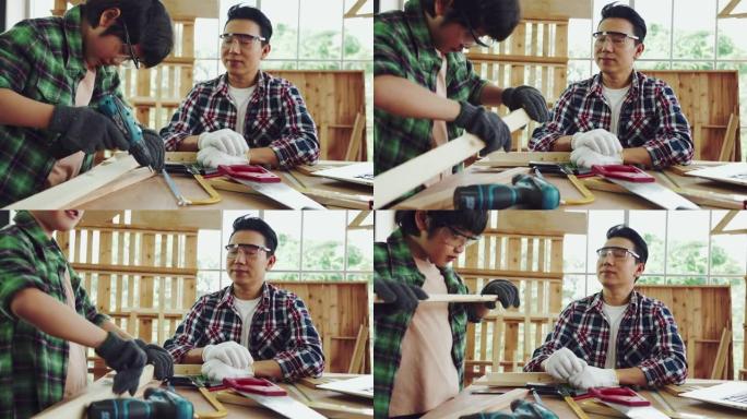 亚洲男人和儿子正在帮助组装房子里的橱柜。