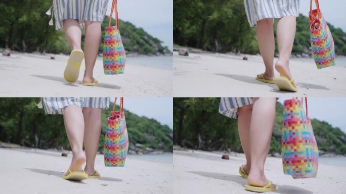 在暑假期间，穿着凉鞋和在沙滩上散步的女人的脚步很平静。独自旅行