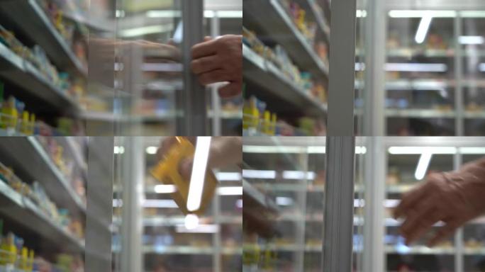 超市里的老人。购物者在商店里打开冰箱。老人在杂货店冰箱里选择食物