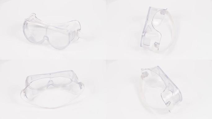 白色塑料防护工作眼镜，带橡胶带。