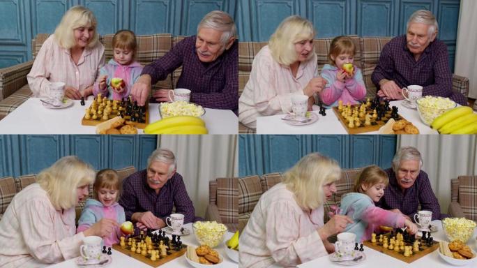 成熟的祖母祖父与女孩孙子在房间的桌子上下棋游戏