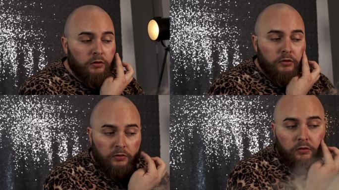 一名男性化妆师在脸颊上涂上腮红的4k视频片段