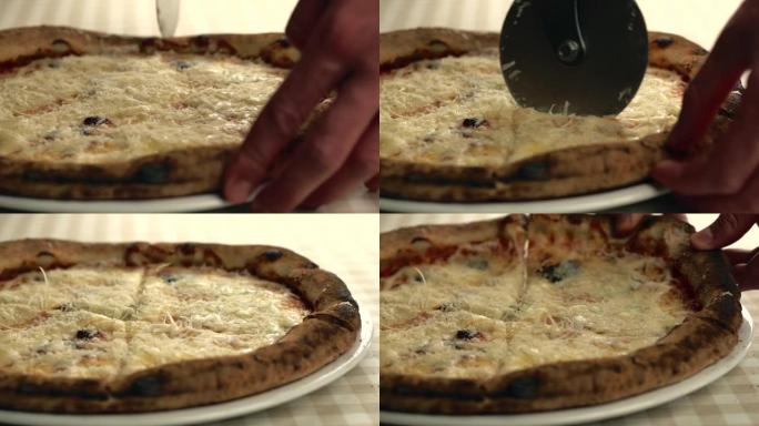大厨切新鲜背热美味意大利披萨的特写镜头。