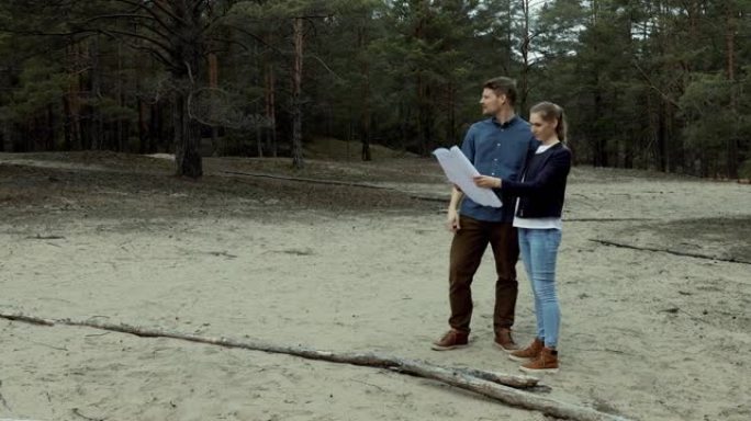 年轻夫妇选择一块土地进行森林小屋建设