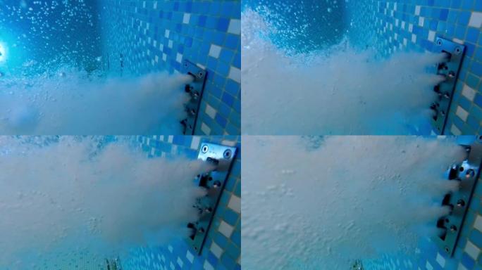 酒店度假村水疗中心游泳池水按摩孔流出的水下慢动作镜头或气泡
