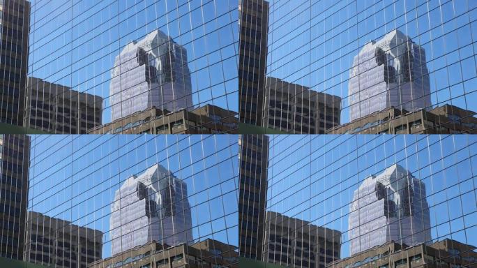 玻璃墙上蒙特利尔办公室摩天大楼的倒影