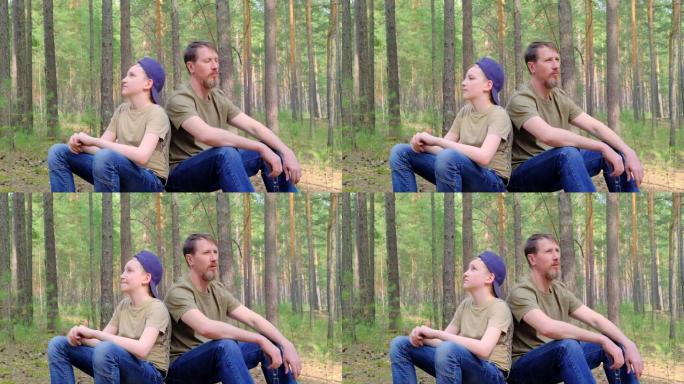 父子俩坐在森林树桩上，深呼吸新鲜空气。慢动作。