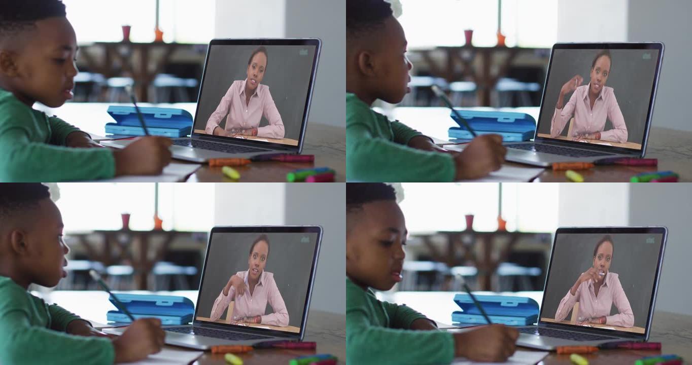 非裔美国男孩在家里做作业时在笔记本电脑上进行视频通话