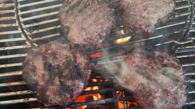 牛肉饼的高分辨率视频，在水壶木炭烤架上烹饪，制作美味的汉堡包。