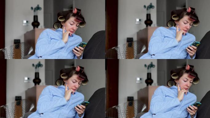 在家使用智能手机的头发卷发器集中的女人