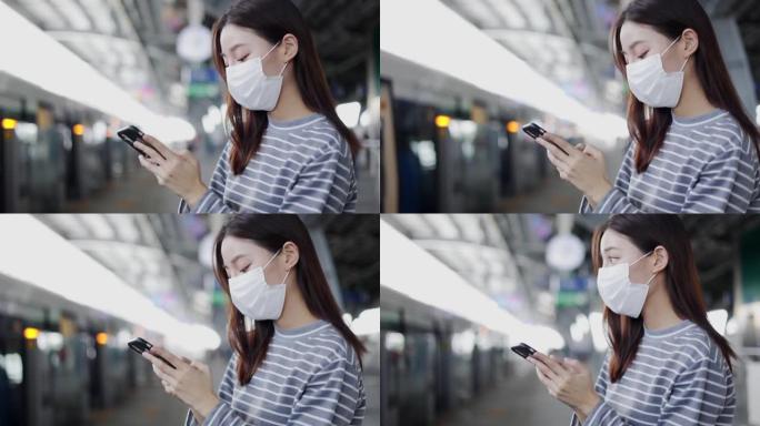 戴着口罩的亚洲妇女在月台上行走，等待电动火车。