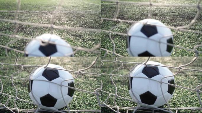 空旷体育场背景下球门网中的足球。4k视频