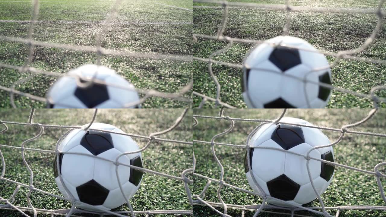 空旷体育场背景下球门网中的足球。4k视频