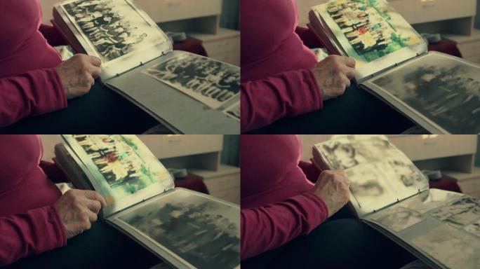 一个女人翻阅一本旧相册，回想起过去。过去的阿纳斯塔斯痛。查看旧照片时对过去的温暖感