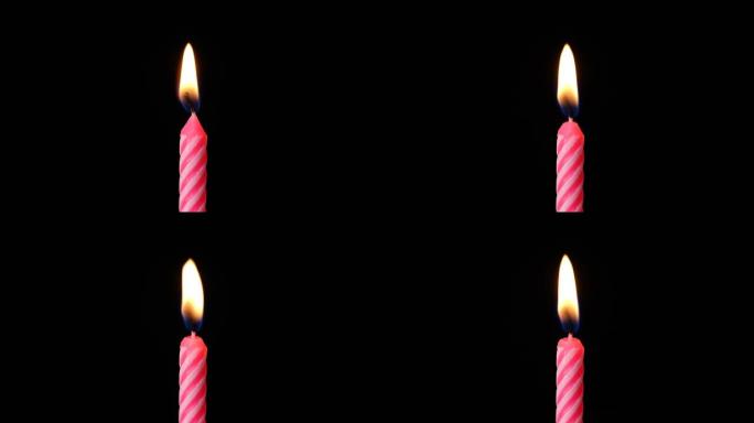 蜡烛火在庆祝生日蛋糕吹在黑色背景孤立。