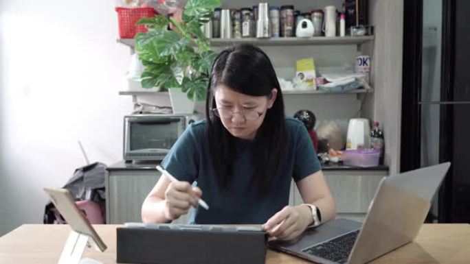 女性平面设计师在家在数字平板电脑上画画。
