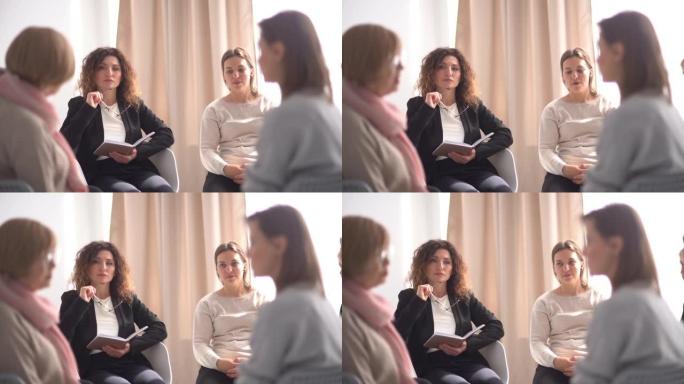 一个哭泣的情绪激动的女人在心理治疗小组讲述她的故事的肖像。心理会议，团体治疗