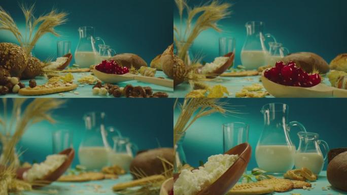 4k精美的装饰桌子组成，带有牛奶乳制品，面包店，浆果，蓝色背景上的花朵。在慢动作的ARRI相机上近距