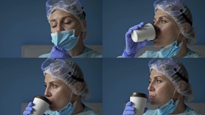 疲倦的女医生或护士的肖像。女人摘下眼镜和口罩，愉快地喝咖啡。新型冠状病毒肺炎大流行期间医护人员的恶劣