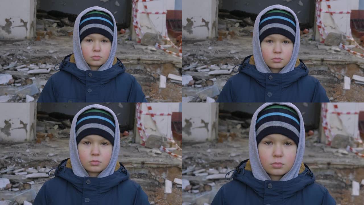 一个无家可归的男孩站在废墟的背景上，忧伤地看着镜头。一个无家可归的孩子，流浪儿