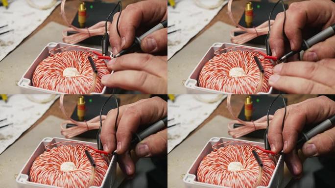 正在修补不寻常线圈的电线进行治疗的人的手的特写。用于固化的米申线圈。