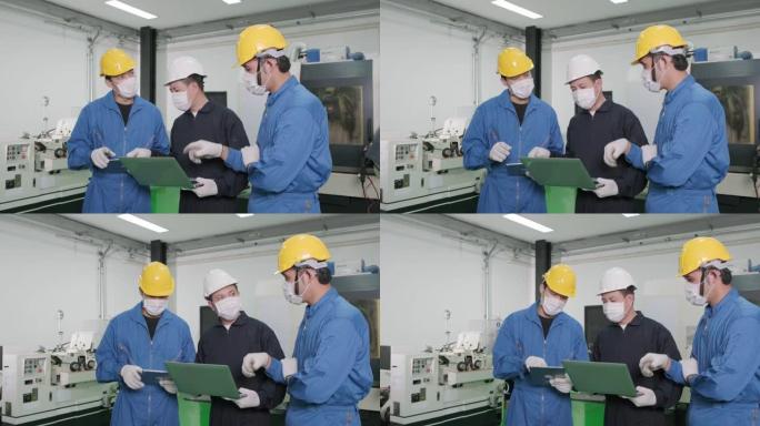亚洲工程师正在向工厂工人解释工作流程。工人或工程师在工厂工作时佩戴处理面罩，以保护粉尘烟雾和电晕病毒