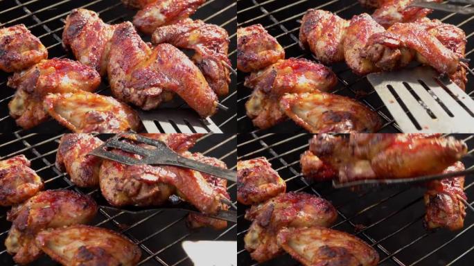 在烤架上油炸和旋转的美味鸡翅的特写镜头