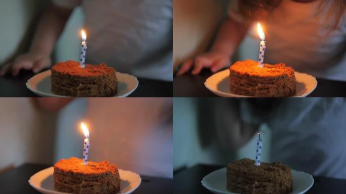 可爱的小女孩在生日蛋糕上吹蜡烛