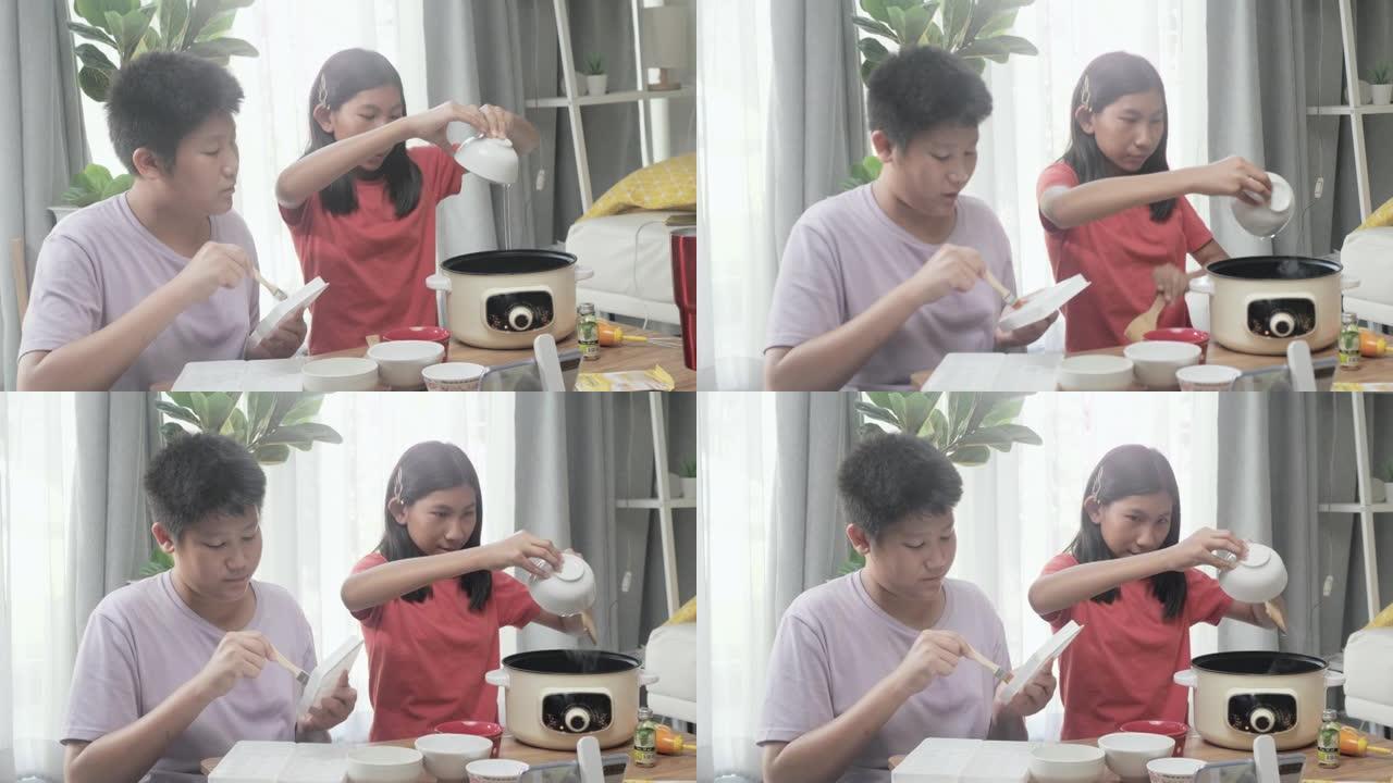 快乐的亚洲儿童，您可以通过智能手机制作视频，在家中一起烹饪一些甜蜜的零食，生活方式概念。