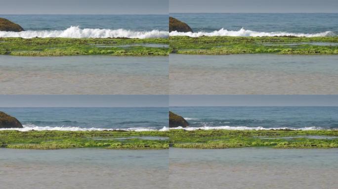 棕色石头和海洋海岸附近无边无际的蓝色海浪