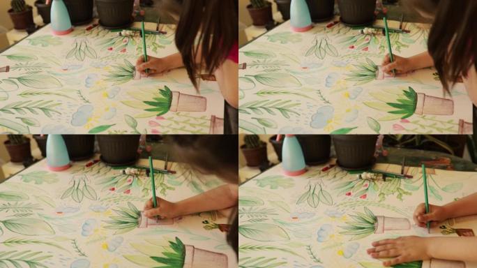 小女孩在纸上画画和着色