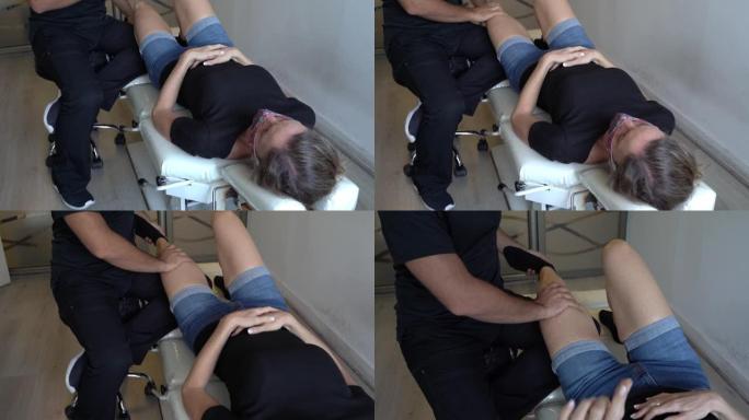 物理治疗师在医生办公室的担架上检查女性患者的左腿