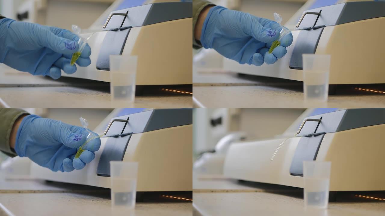 一位生物学家分析实验室专用设备上的液体
