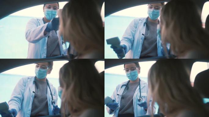 4k视频片段，一位有吸引力的年轻女护士在covid疫苗中通过室外拍摄一名妇女的体温