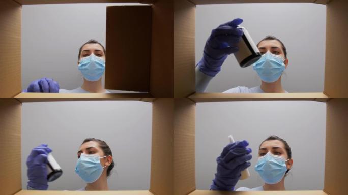 戴口罩的女人用药品打开包装箱