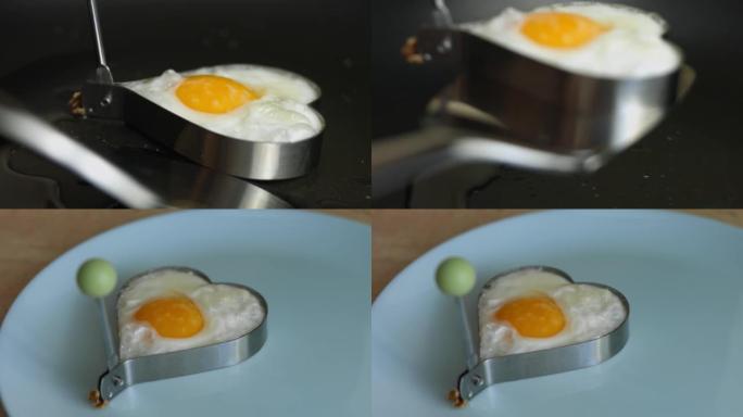 在煎锅中烹饪心形煎蛋。把鸡蛋放在盘子里。为3月8日做惊喜早餐