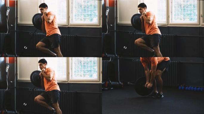 一名运动男子在健身房做单腿地雷深蹲运动