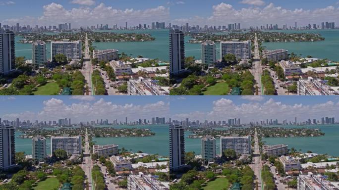 在刮风，阳光明媚的日子里，沿着威尼斯之路，在威尼斯群岛上空，俯瞰迈阿密市中心的空中广角视图。无人机制