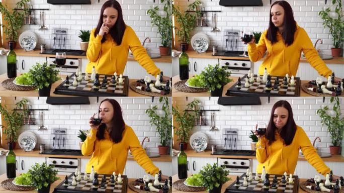 体贴的年轻女子下棋，喝红酒，发明搬家。酒精女性在逻辑棋盘游戏中玩耍，站在厨房