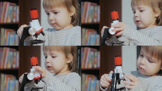 孩子和显微镜。幼儿玩孩子的发育玩具。儿童认知教育玩具。