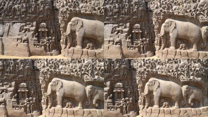 泰米尔纳德邦Mahabalipuram的整体岩石面板上的古代历史神，人类和动物雕塑的石雕。马哈巴利普