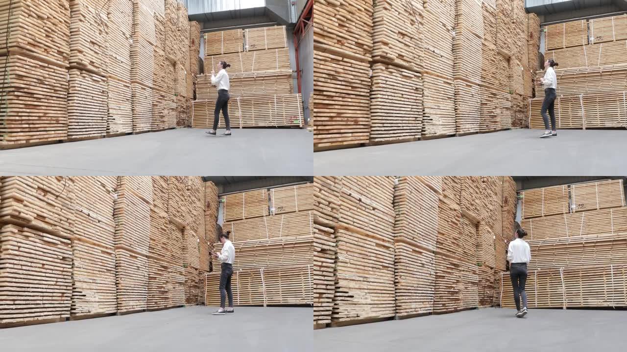 工业木工工厂的女商人-用现代机器生产木板