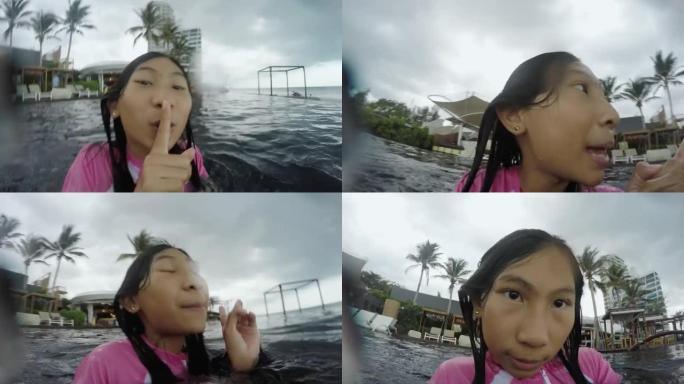 快乐的亚洲女孩在酒店度假期间在游泳池放松，有家庭生活理念。