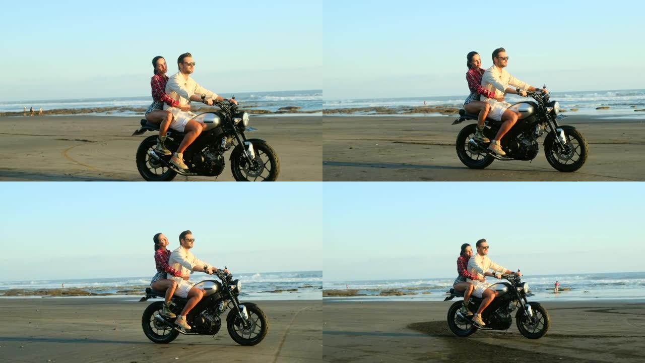 在海边的海滩上，快乐快乐的情侣在定制摩托车上恋爱