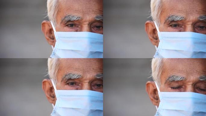 戴着医用口罩保护自己免受电晕病毒大流行的印度老人的半脸肖像。有复制空间