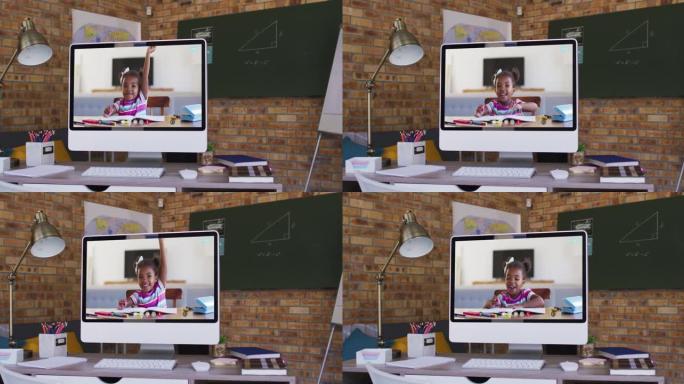 在学校桌子上的计算机上进行视频通话的非裔美国女孩的网络摄像头视图