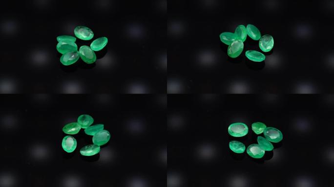 黑色背景上转动桌上的天然绿宝石