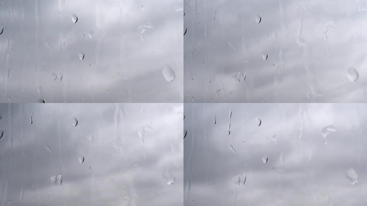 灰云背景下雨湿玻璃的延时
