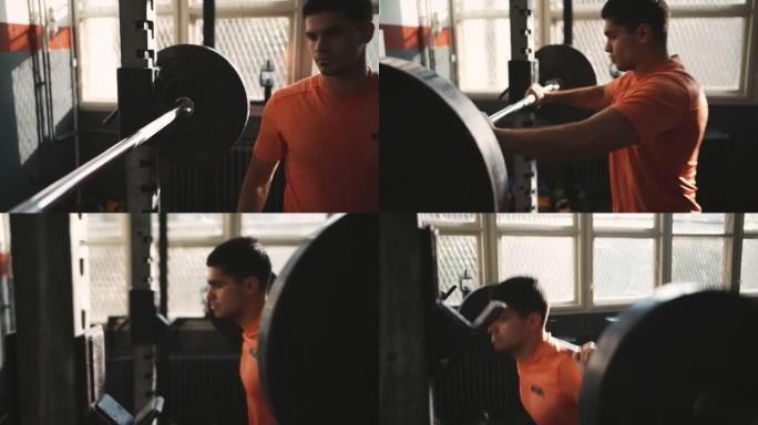 年轻的运动型男子在健身房的杠铃上举重